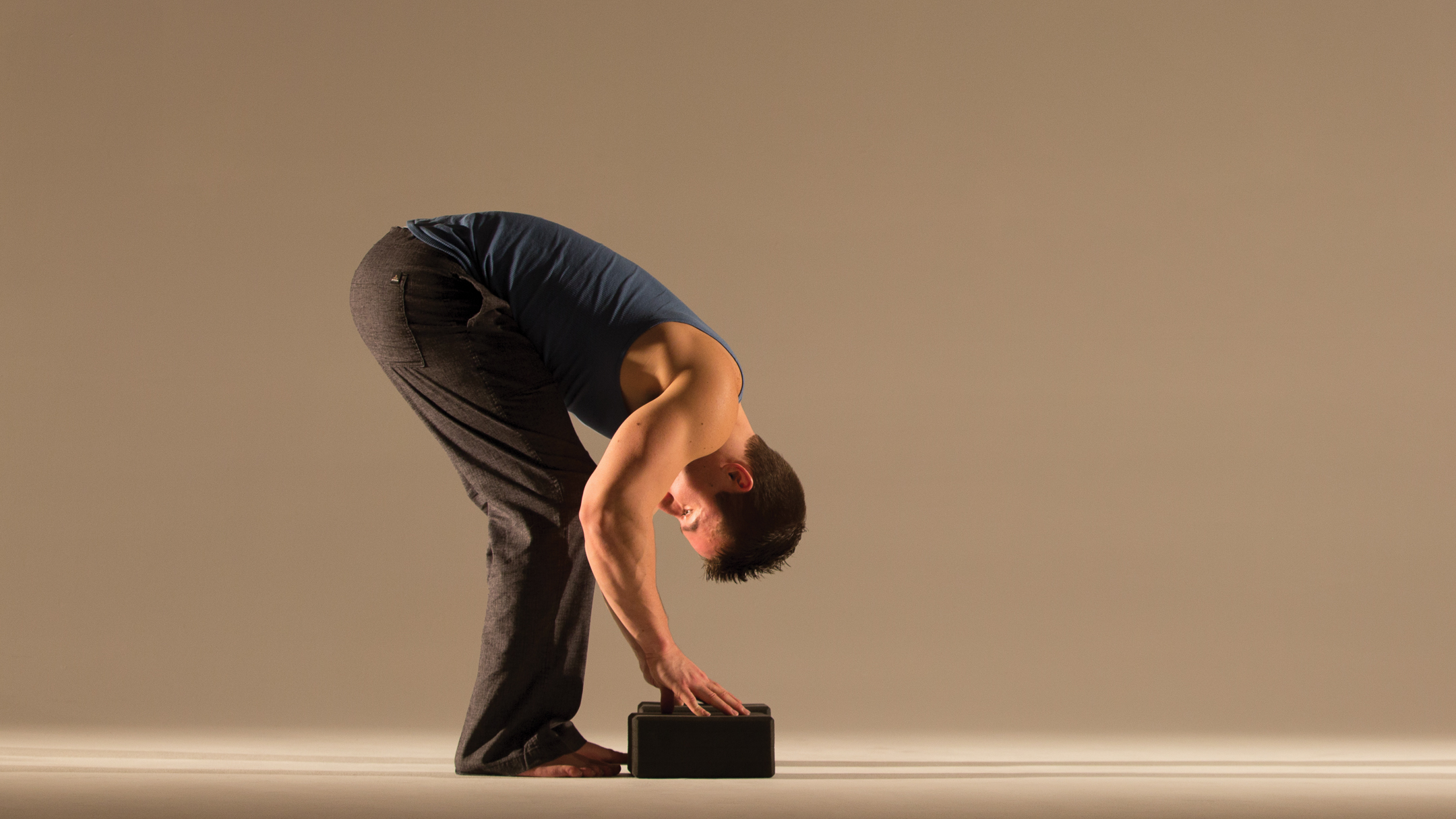 Young couple practicing acro yoga on mat in studio together. Acroyoga.  Couple yoga. Partner yoga. - Stock Image - Everypixel